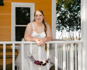Ashley + Ethan Bride with bouquet ring on porch