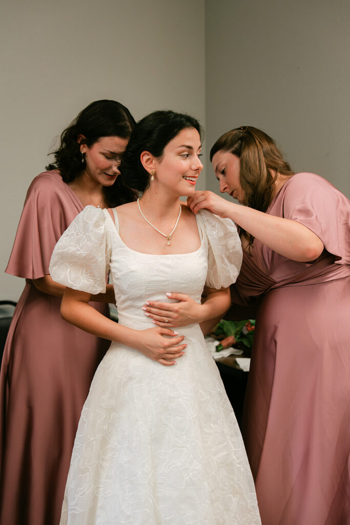 Getting ready photo of bride in her wedding dress